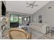 Living room with a stone fireplace, view of a lake, and neutral decor at 3124 Windrush Bourne # 10, Sarasota, FL 34235