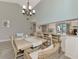 Light-filled dining area with a large wooden table and wicker chairs at 3124 Windrush Bourne # 10, Sarasota, FL 34235