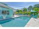 Inviting pool area with volleyball net, lounge chairs, and basketball hoop at 1655 Memory Ln, Sarasota, FL 34231