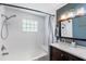 Updated bathroom with a glass block window over the bathtub and a modern vanity at 105 2Nd Se Ave, Ruskin, FL 33570