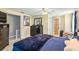 Comfortable bedroom featuring a ceiling fan, tile floor, and a blue comforter on the bed at 105 2Nd Se Ave, Ruskin, FL 33570
