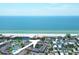 Aerial view of the condo complex near a beachfront with tennis courts and a swimming pool at 1900 Gulf N Dr # 4, Bradenton Beach, FL 34217