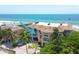 Aerial shot of a beachfront condo complex with private balconies, tile roofs, and lush tropical landscaping at 1900 Gulf N Dr # 4, Bradenton Beach, FL 34217