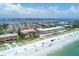 Aerial view of condominium complex with beach access to the Gulf of Mexico and views of waterfront cityscape at 1900 Gulf N Dr # 4, Bradenton Beach, FL 34217