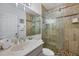 Beautiful bathroom with stone-look tile, glass-enclosed shower, and modern vanity at 1900 Gulf N Dr # 4, Bradenton Beach, FL 34217