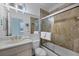 Bathroom featuring decorative stone-look tile, a glass-enclosed shower, and a clean vanity at 1900 Gulf N Dr # 4, Bradenton Beach, FL 34217