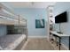 Bedroom features bunk beds, desk, and built-in shelves, offering comfort and functionality at 1900 Gulf N Dr # 4, Bradenton Beach, FL 34217