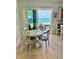 Inviting dining area with Gulf views that seats four, creating the perfect spot for casual dining at 1900 Gulf N Dr # 4, Bradenton Beach, FL 34217