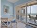 Bright dining area with patio doors to the balcony providing natural light and beautiful ocean views at 1900 Gulf N Dr # 4, Bradenton Beach, FL 34217