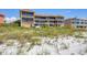 Condo building set on a beach, featuring multiple floors and ample balconies for ocean views at 1900 Gulf N Dr # 4, Bradenton Beach, FL 34217
