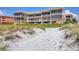 Beachside condo complex featuring multiple floors of screened-in balconies, spiral staircases, and direct beach access at 1900 Gulf N Dr # 4, Bradenton Beach, FL 34217