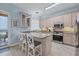 Bright kitchen boasts white wood cabinets, stainless appliances, and bar seating overlooking the ocean at 1900 Gulf N Dr # 4, Bradenton Beach, FL 34217