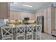 Bright kitchen featuring counter seating, stainless steel appliances and classic cabinetry at 1900 Gulf N Dr # 4, Bradenton Beach, FL 34217