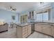 Open-concept kitchen with stainless steel appliances, breakfast bar, and bright dining area at 1900 Gulf N Dr # 4, Bradenton Beach, FL 34217