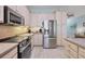 Modern kitchen features stainless steel appliances, sleek countertops, and wood-look tile flooring at 1900 Gulf N Dr # 4, Bradenton Beach, FL 34217