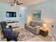 Relaxing living room features comfortable seating, a large TV, and stylish décor in a light, airy space at 1900 Gulf N Dr # 4, Bradenton Beach, FL 34217