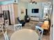 Open concept living area features tile floors, ceiling fan, with easy access to the kitchen and front entry at 1900 Gulf N Dr # 4, Bradenton Beach, FL 34217