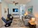 Comfortable living room featuring recliner, sofa, large screen TV, and access to the rest of the home at 1900 Gulf N Dr # 4, Bradenton Beach, FL 34217
