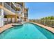 A luxurious pool featuring a hot tub, outdoor furniture and a view of the clear blue sky at 1900 Gulf N Dr # 4, Bradenton Beach, FL 34217