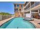 Exterior view of a community pool with a hot tub, lounge chairs, and access to beach at 1900 Gulf N Dr # 4, Bradenton Beach, FL 34217