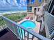 Balcony view of a stunning community pool, hot tub, beach access, and the ocean beyond at 1900 Gulf N Dr # 4, Bradenton Beach, FL 34217
