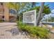 Attractive property sign for 1900 Marbella Villas with lush landscaping, a sidewalk, and palm trees at 1900 Gulf N Dr # 4, Bradenton Beach, FL 34217