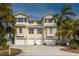 Three-story house with three-car garage and palm trees at 447 Canal Rd # 447, Sarasota, FL 34242