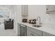 Wet bar with wine cooler, sink, and gray cabinets at 5713 Cheech Gln, Lakewood Ranch, FL 34211