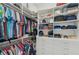 Large walk-in closet with shelves and hanging rods at 5713 Cheech Gln, Lakewood Ranch, FL 34211