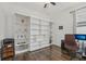 Home office with built-in shelving and hardwood floors at 5713 Cheech Gln, Lakewood Ranch, FL 34211