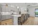 Modern kitchen with gray cabinets, quartz countertops and a spacious island with seating at 5713 Cheech Gln, Lakewood Ranch, FL 34211