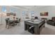 Game room features a pool table, seating area, and dining table at 5713 Cheech Gln, Lakewood Ranch, FL 34211