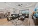 Spacious living room featuring a large sectional sofa and a view to the kitchen and dining area at 5713 Cheech Gln, Lakewood Ranch, FL 34211