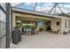 Covered patio with outdoor kitchen, seating area, and TV at 5713 Cheech Gln, Lakewood Ranch, FL 34211