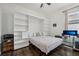 Bedroom with a Murphy bed, built-in shelving, and a workspace at 5713 Cheech Gln, Lakewood Ranch, FL 34211