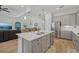 Open concept kitchen with island, stainless steel appliances, and view of living room at 5713 Cheech Gln, Lakewood Ranch, FL 34211