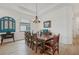 Elegant dining room featuring a rustic wooden table and view of a decorative blue accent wall at 5713 Cheech Gln, Lakewood Ranch, FL 34211