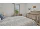 Bedroom with crib, dresser, and window with blinds at 5713 Cheech Gln, Lakewood Ranch, FL 34211