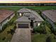 Luxury two-story house with tile roof and lush landscaping near golf course at 5713 Cheech Gln, Lakewood Ranch, FL 34211