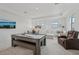 Game room with pool table, sectional sofa, and large TV at 5713 Cheech Gln, Lakewood Ranch, FL 34211