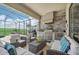 An outdoor kitchen with seating area and grill at 5713 Cheech Gln, Lakewood Ranch, FL 34211