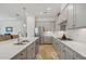 Modern kitchen with gray cabinets, quartz countertops, and stainless steel appliances at 5713 Cheech Gln, Lakewood Ranch, FL 34211
