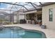 Outdoor oasis with a pool, built-in grill, and covered patio at 5713 Cheech Gln, Lakewood Ranch, FL 34211