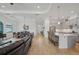 Modern kitchen with gray cabinets, a large island, and views of the living and dining areas at 5713 Cheech Gln, Lakewood Ranch, FL 34211