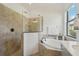 Spa-like bathroom featuring a soaking tub and a large shower at 5713 Cheech Gln, Lakewood Ranch, FL 34211