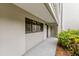 Condo hallway showcasing a private entrance and tropical plants at 5757 Gulf Of Mexico Dr # 109, Longboat Key, FL 34228