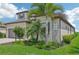Two-story home with tile roof, gray garage door, and tropical landscaping at 5713 Cheech Gln, Lakewood Ranch, FL 34211