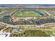 Aerial view of community with golf course, pool, and tennis courts at 5713 Cheech Gln, Lakewood Ranch, FL 34211