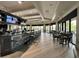 Community bar with seating, large screen TV and modern decor at 5713 Cheech Gln, Lakewood Ranch, FL 34211