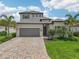 Two-story home boasts attractive curb appeal with a gray tile roof and lush landscaping at 5713 Cheech Gln, Lakewood Ranch, FL 34211